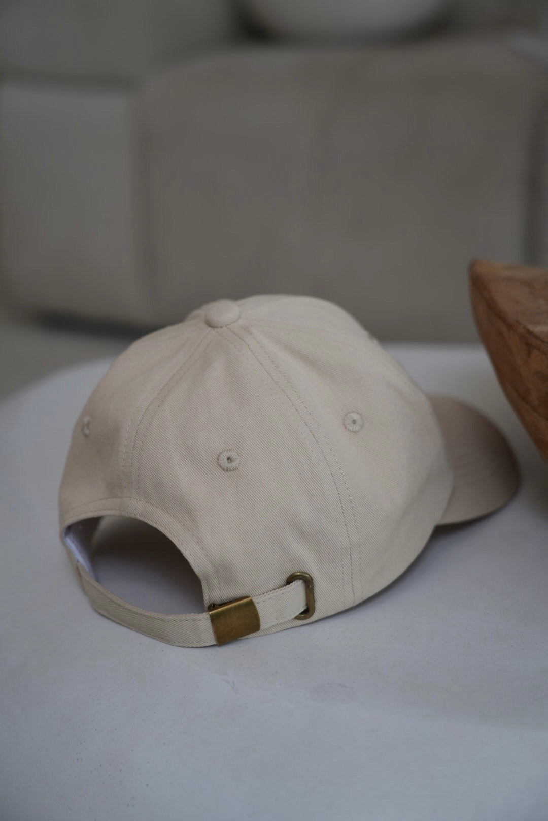 Beige cap on a white surface with a blurred background