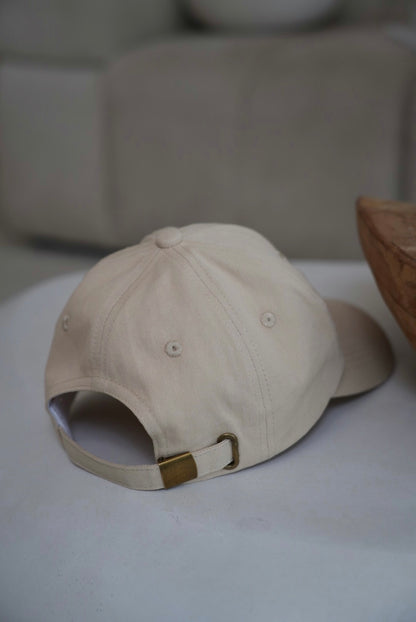 Beige cap on a white surface with a blurred background